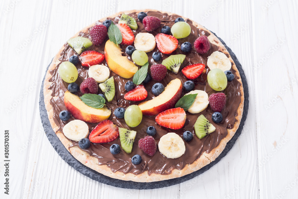 Fruit pizza with nut nougat cream , fruit and berries Fruit pizza with nut nougat cream , fruit and berries