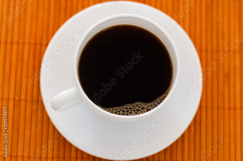 Top view of a white coffee cup on the table