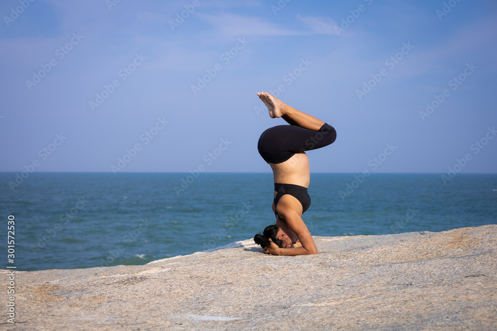  Asian pregnant woman yoga on the beach sunset summer time