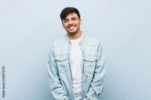 Obraz na plátně Young hispanic cool man happy, smiling and cheerful.