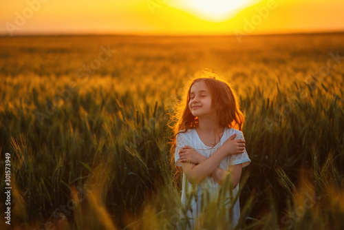 Fototapeta Naklejka Na Ścianę i Meble -  Little girl in a wheat field