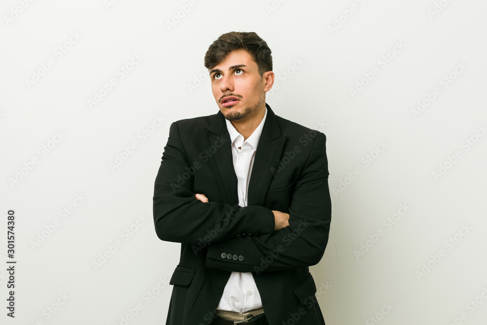 Young business hispanic man tired of a repetitive task. Young business hispanic man tired of a repetitive task.