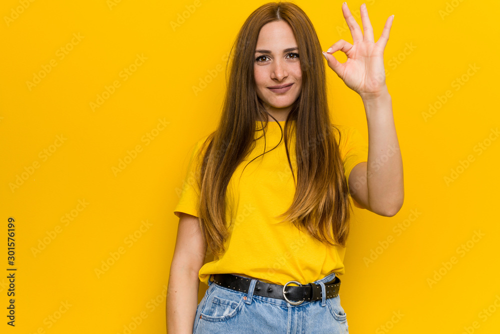 Young ginger redhead woman cheerful and confident showing ok gesture.