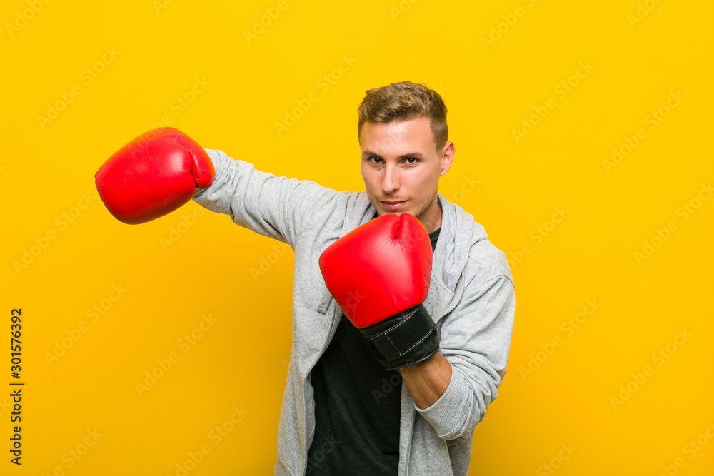 Young caucasian man wearing a boxing gloves