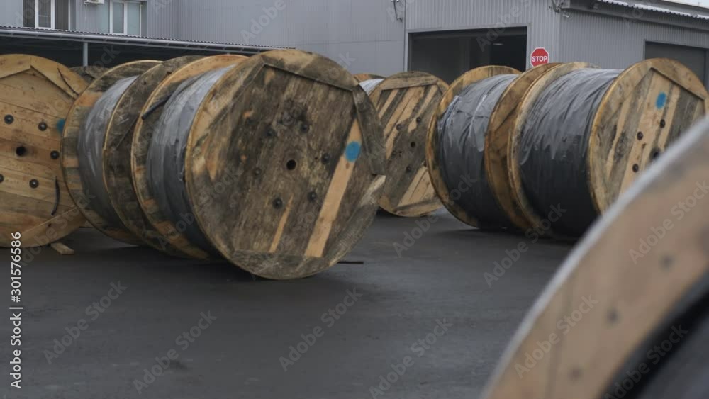 Wooden cable spools at the plant for the production of cable. Finished products cable plant. Wooden cable spools at the plant for the production of cable. Finished products cable plant.