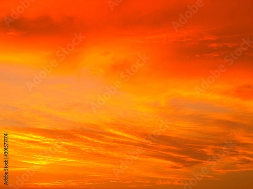 An orange evening sky with clouds © Marcos