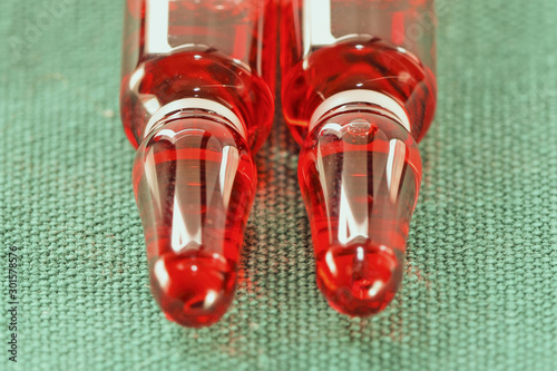 Ampules with red liquid OHB 12 vitamin for injection closeup-  influenza harry photo