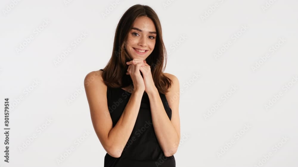 Beautiful charming brown haired girl cutely posing on camera over white background Beautiful charming brown haired girl cutely posing on camera over white background