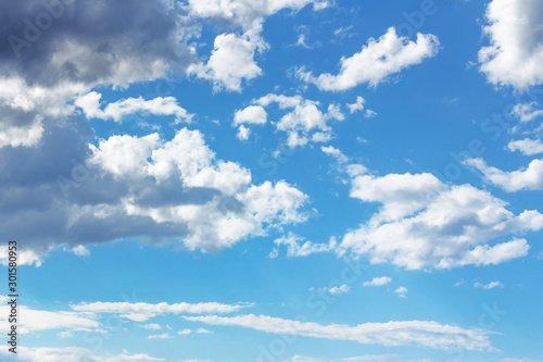 blue sky with clouds on a sunny april day. dynamic formations in windy weather