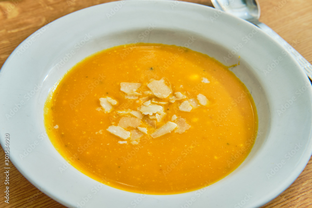 Hokaido pumpkin soup on white plate Hokaido pumpkin soup on white plate