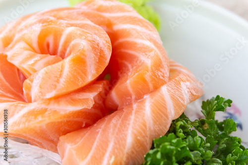 Salmon slice arranged beautiful with wasabi and vegetable ,close up