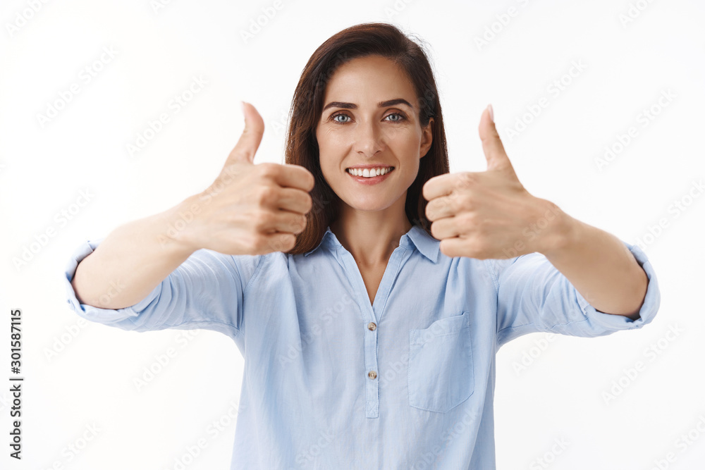 Excellent decision. Supportive good-looking adult 30s woman with tattoos, female entrepreneur give thumbs-up approval sign, smiling entertained delighted hear good concept, accept terms Excellent decision. Supportive good-looking adult 30s woman with tattoos, female entrepreneur give thumbs-up approval sign, smiling entertained delighted hear good concept, accept terms