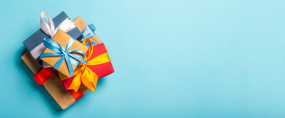 Stack of gifts on a blue background. Gift concept for a loved one, holiday, Christmas. Banner. Flat lay, top view