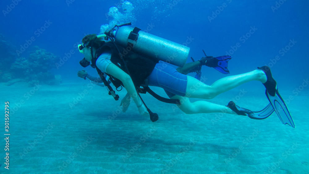 Diving with air balloon in the red sea. Instructor. Girl and coral reefs. Traveling lifestyle. Water sports. Beach holidays. Diving with air balloon in the red sea. Instructor. Girl and coral reefs. Traveling lifestyle. Water sports. Beach holidays.