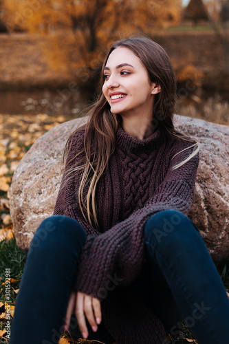 Portrait of a beautiful smiling girl , autumn sunny day in the park