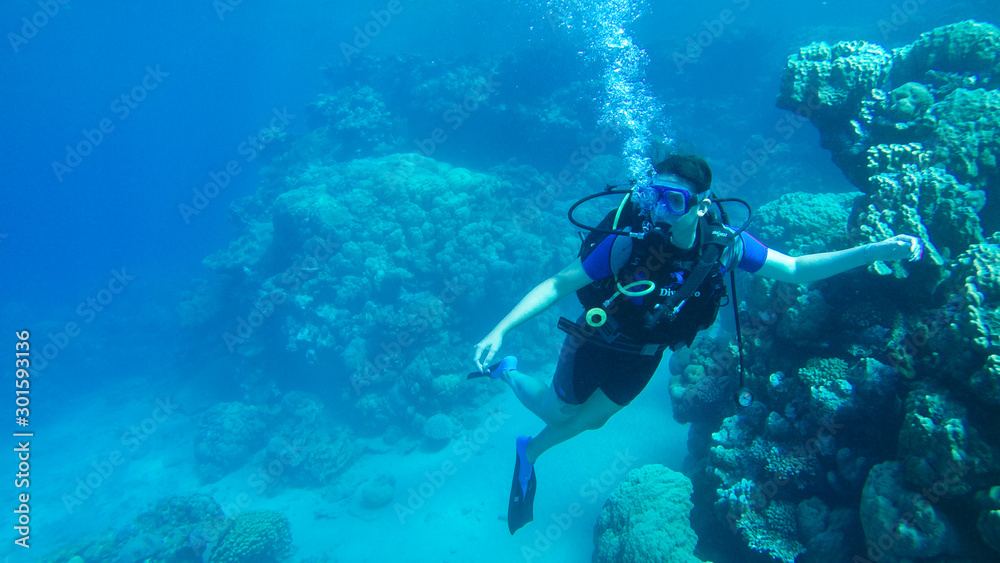 Diving with air balloon in the red sea. Instructor. Girl and coral reefs. Traveling lifestyle. Water sports. Beach holidays.