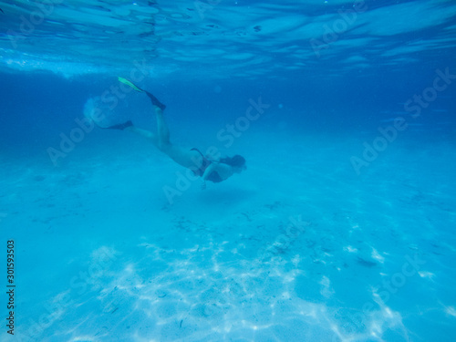 Diving in the red sea. Sexy girl in bikini and mask. Snorkeling. Traveling lifestyle. Water sports. Beach holidays.