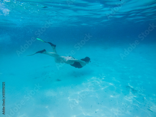 Diving in the red sea. Sexy girl in bikini and mask. Snorkeling. Traveling lifestyle. Water sports. Beach holidays. © Yaroslav