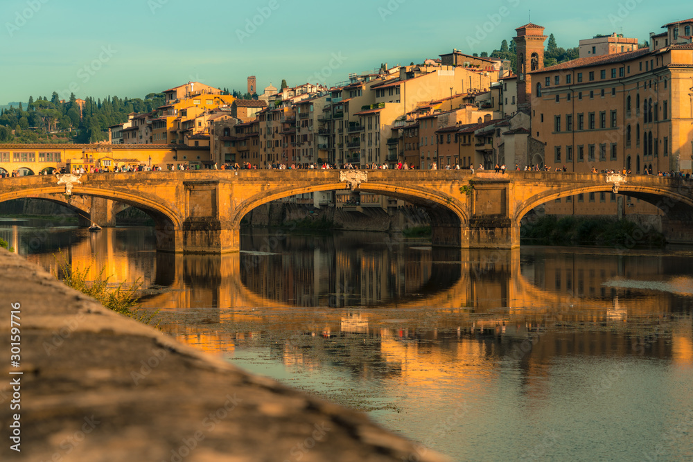 Old river bridges in Florence at sunset. Travel destination Tuscany, Italy