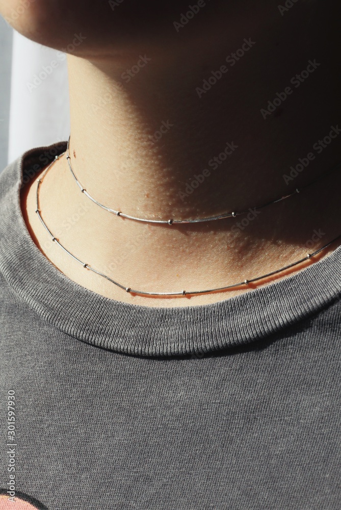 Tender jewerly on female neck, close up shot