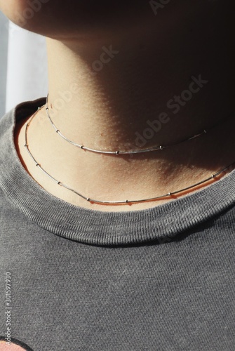 Tender jewerly on female neck, close up shot