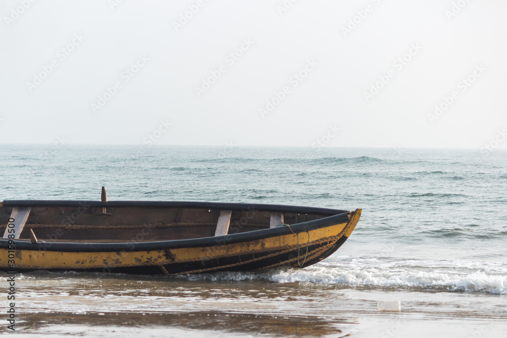 Isolated boat standing on beach, Rushikonda beach, Vizag, India Isolated boat standing on beach, Rushikonda beach, Vizag, India