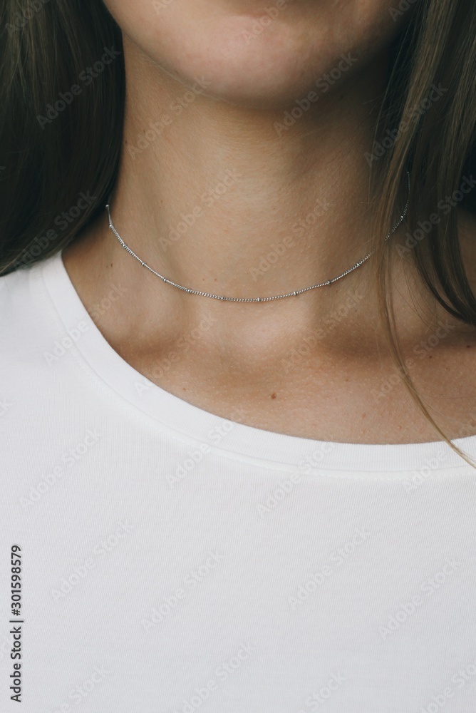 Tender jewerly on female neck, close up shot