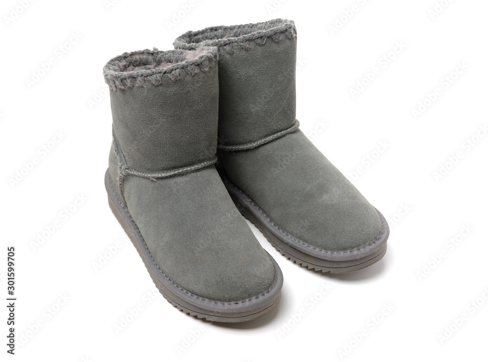 Pair of female grey grunge style boots isolated on a white background