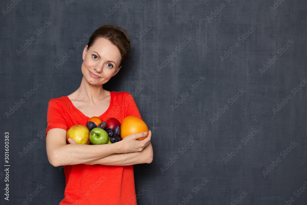 Portrait of happy cute girl holding ripe fresh fruits in hands Portrait of happy cute girl holding ripe fresh fruits in hands