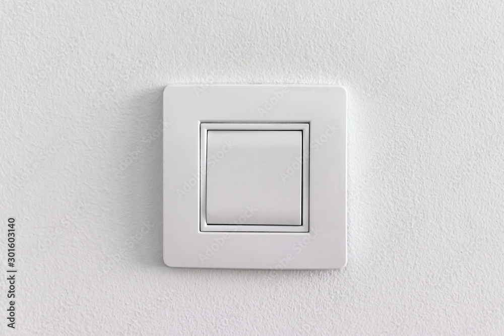Single white light electric switch on a wall Single white light electric switch on a wall