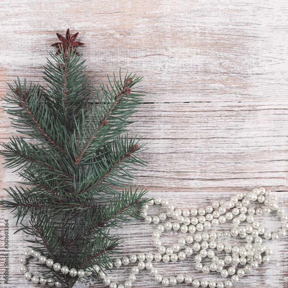 Christmas card. New Year accessories on white wooden background. Christmas celebration concept with pine tree and pearls. Place for text, Flat lay, top view, copy space Christmas card. New Year accessories on white wooden background. Christmas celebration concept with pine tree and pearls. Place for text, Flat lay, top view, copy space