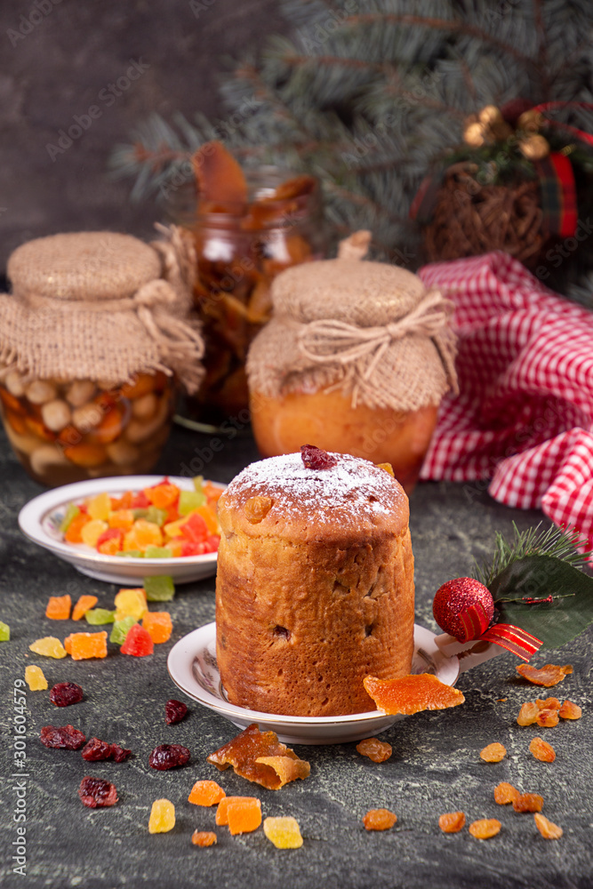Fototapeta premium Italian sweet dessert panettone. rich Italian bread made with eggs, fruit, and butter and typically eaten at Christmas. copy space