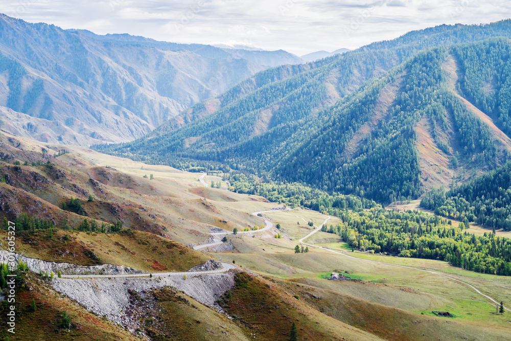 Serpentine mountain road. View of the Chuysky tract from the Chike-Taman pass, Altai mountains, Russia Serpentine mountain road. View of the Chuysky tract from the Chike-Taman pass, Altai mountains, Russia