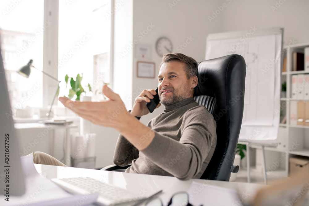 Successful entrepreneur or agent with smartphone by ear while consulting client Successful entrepreneur or agent with smartphone by ear while consulting client