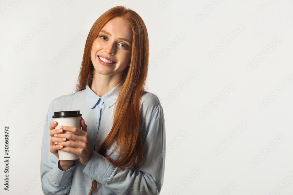 beautiful young woman with red hair with a drink in hand on a white background beautiful young woman with red hair with a drink in hand on a white background