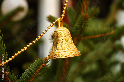 One golden Christmas bell on the Christmas tree