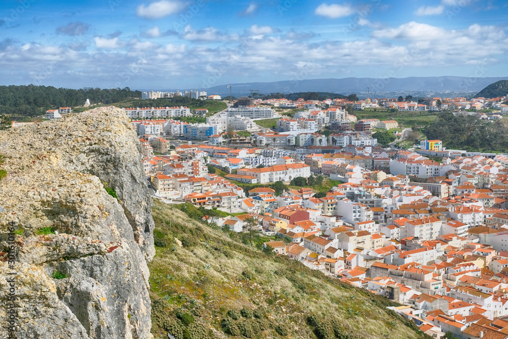 The town and beach of Nazare in Portugal on the shores of the Atlantic Ocean on a sunny day