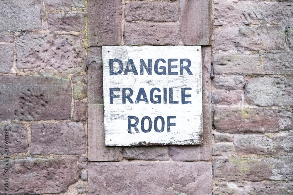 Fototapeta Danger fragile roof sign on wall at farm house