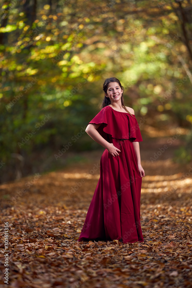 Portrait of a teenage girl in red dress