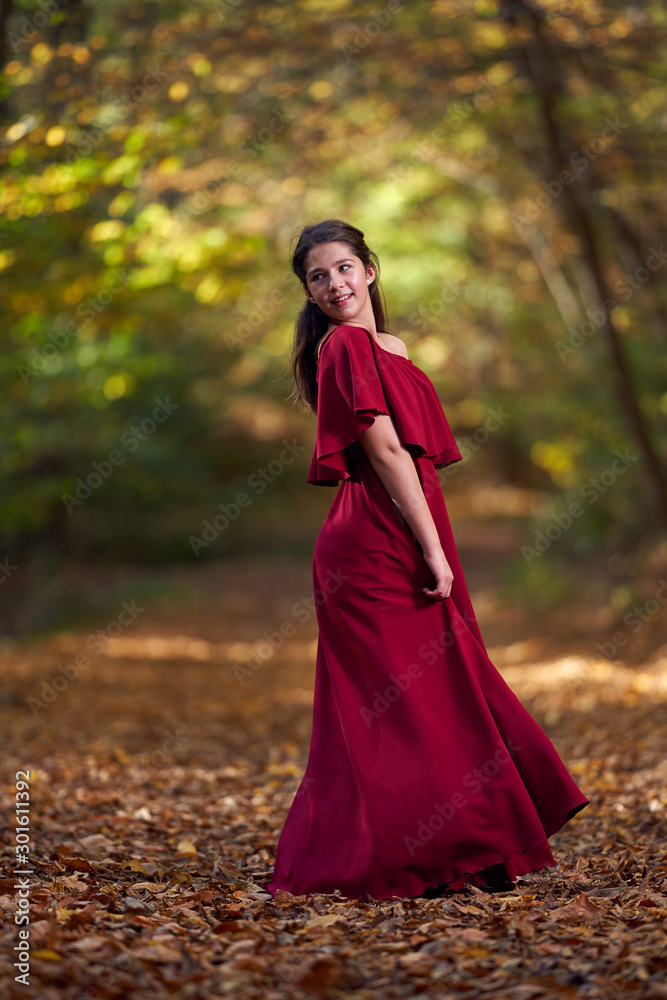 Portrait of a teenage girl in red dress