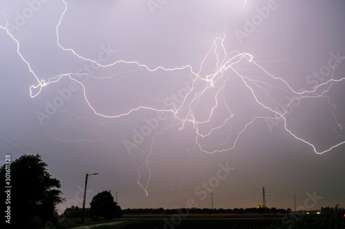 Lightning is a naturally occurring electrostatic discharge during which two electrically charged regions in the atmosphere or ground temporarily equalize themselves. photo