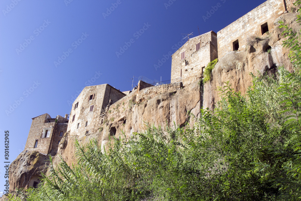Pitigliano, one of the best town in Tuscany, Italy. Panoramic view from a path in a forest sorrounding the city.