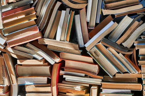 Pile of old books in dramatic dim light