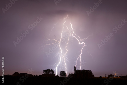 Lightning is a naturally occurring electrostatic discharge during which two electrically charged regions in the atmosphere or ground temporarily equalize themselves.