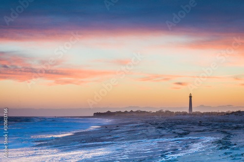 Cape May NJ lighthouse and Atlantic Ocean at sunset in springtime  photo