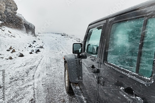 Off road car driving in Iceland, snow on a wild landscape