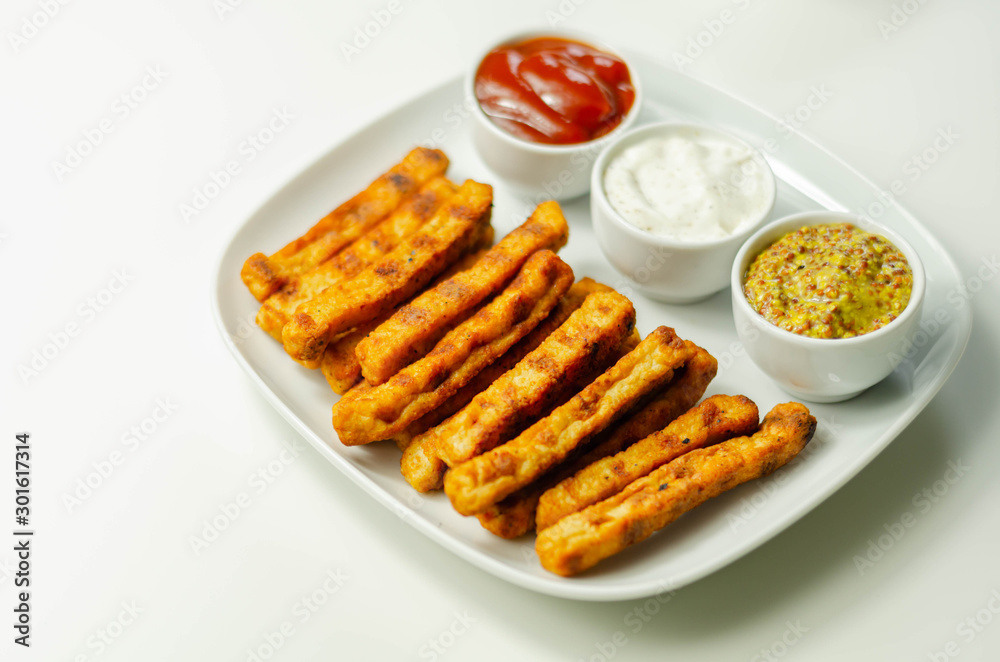 Roast chicken formed in straws, bites of succulent chicken breast with different sauces Roast chicken formed in straws, bites of succulent chicken breast with different sauces