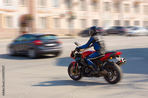 Biker rides on a city road. © redly