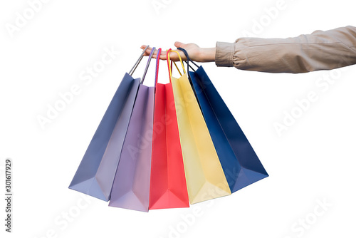 Five colored bags for shopping in a female hand. Close-up, isolate. Shopping