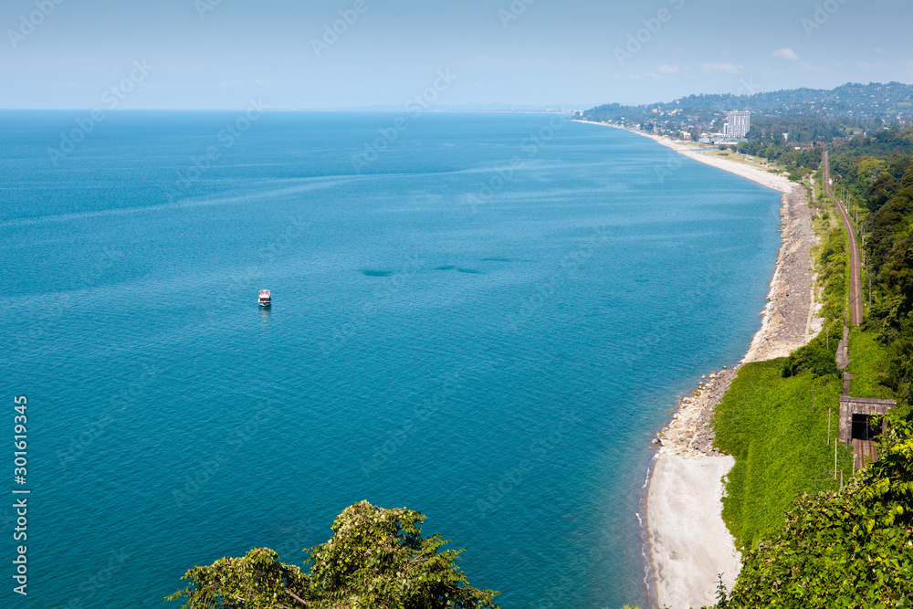 Beautiful summer view of the Black sea from Botanical garden in Batumi, Georgia. Bright landscape with green-blue water and a lot of greenery on the hills